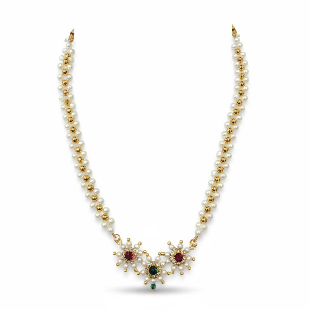 Pearl necklace with gold accents and gemstones on a white background