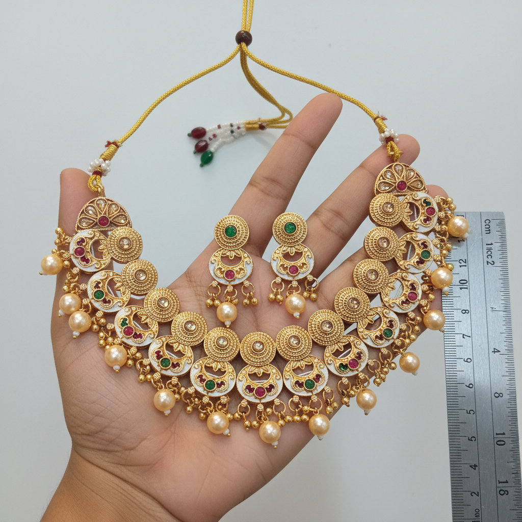 Gold necklace with matching earrings on a white background