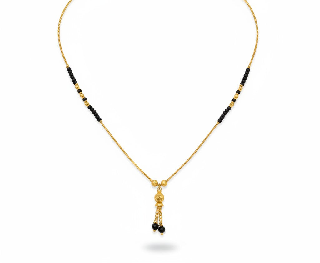 Fancy gold plated mangalsutra with black beads on a white background